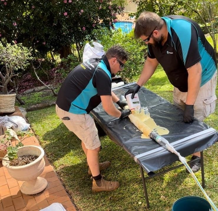 cheap Plumber inspecting a drain for pipe relining services